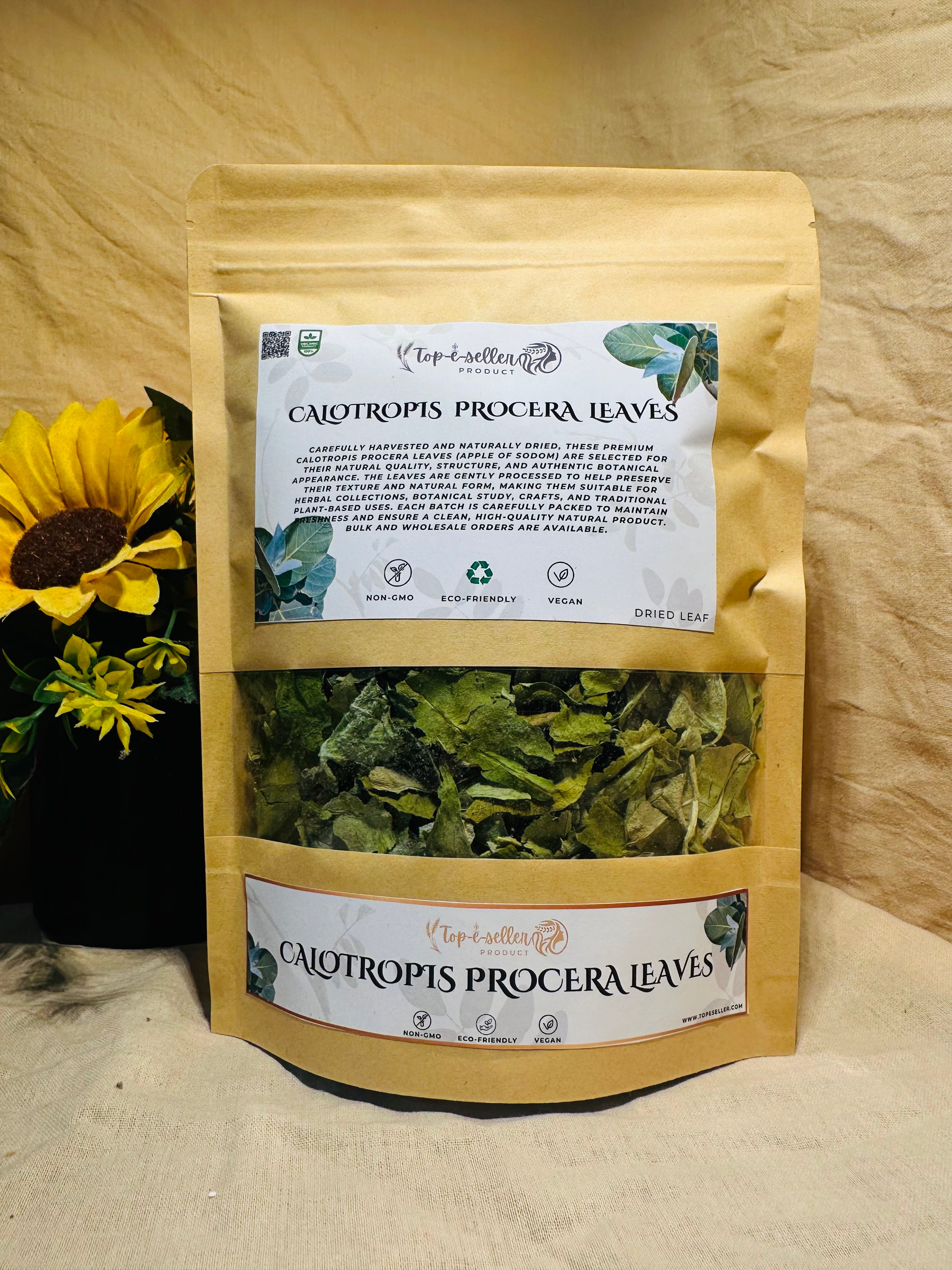 Packaged Calotropis procera leaves with a sunflower in the background on a wooden surface.