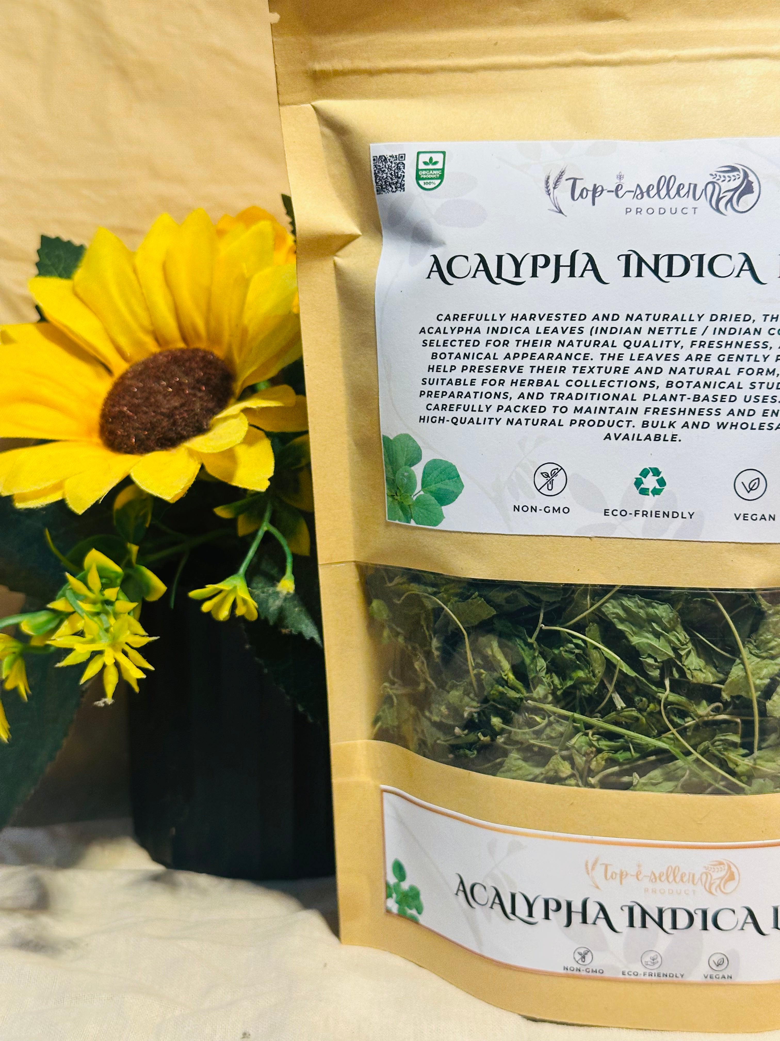 Bag of Acalypha Indica with a yellow flower in the background