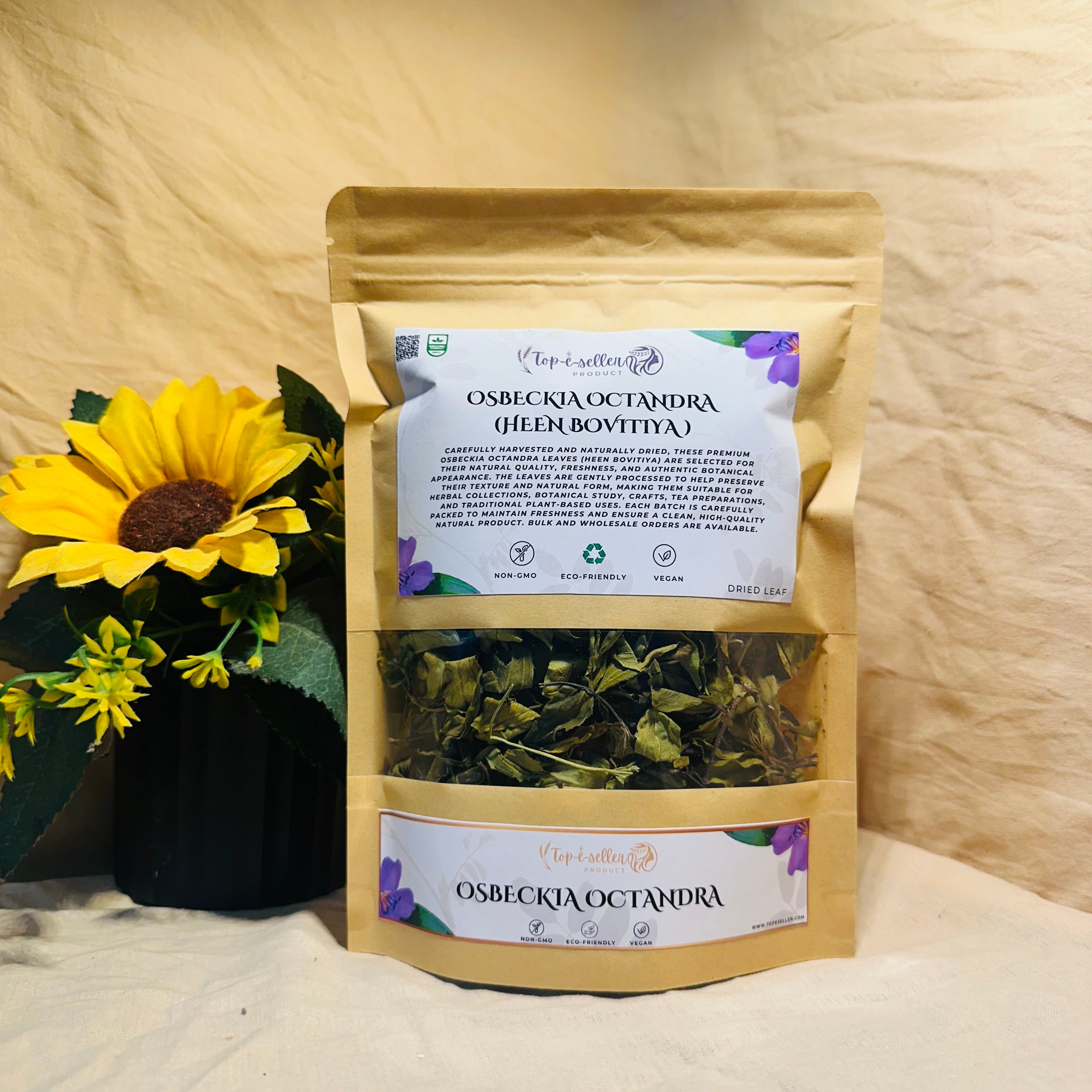 Packaged Osbeckia octandra with a sunflower on a wooden surface